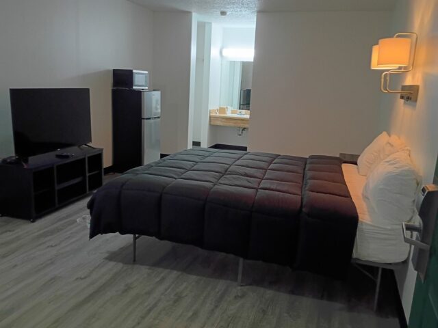 Renovated king room with smart TV and mini fridge at The Hastings Inn Parsons