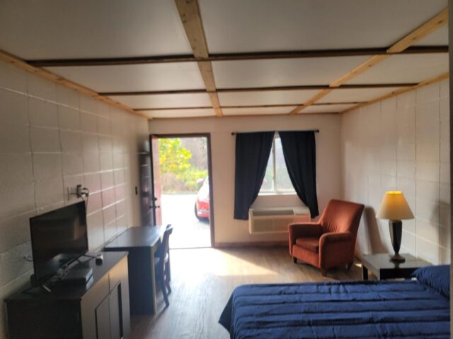 Renovated queen room with desk and smart TV at Towne and Village Extended Stay